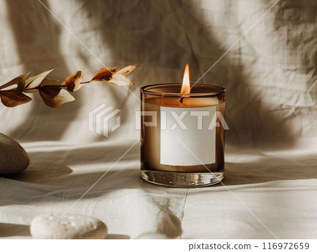 Candle mockup, An Elegant Candle with a Flickering Flame Against a Soft Fabric Creates a Warm Atmosphere 116972659