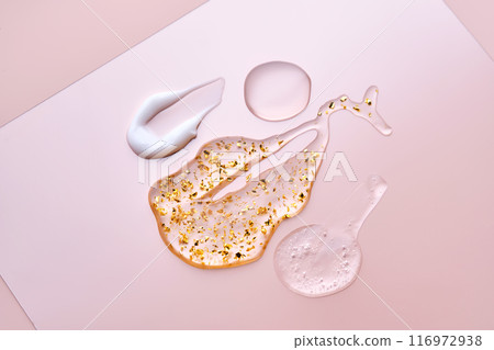 Texture of face serum, cream, oil and serum with 24k gold on a pink background. Texture of face serum, cream, oil and serum with 24k gold on a pink background. 116972938