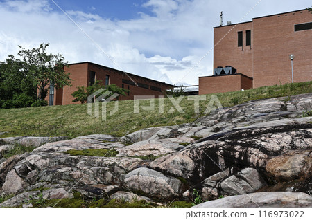 brick buildings atop rocky hill under a blue sky brick buildings atop rocky hill under a blue sky 116973022