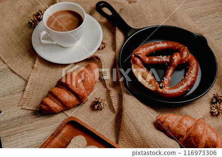 Breakfast with coffee and croissant. Breakfast with coffee and croissant. 116973306