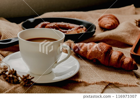 Breakfast with coffee and croissant. Breakfast with coffee and croissant. 116973307