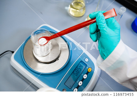 Top view woman is using laboratory balances to weigh powder samples 116973455