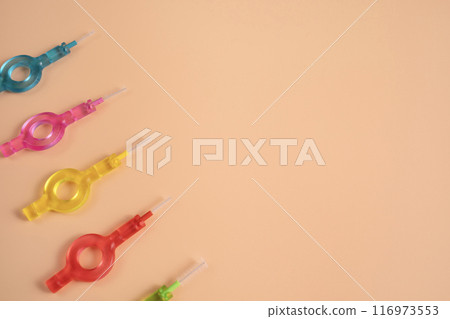 Mockup Many Colorful Interdental, Dental Brush Angle, Toothpick for Teeth Cleaning, Braces On Yellow Peach Background. Flatly Dentistry, Oral Health Hygiene. Copyspace Flossing Oral Brush, Horizontal 116973553