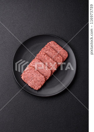 Delicious canned pink ham with salt, spices and herbs Delicious canned pink ham with salt, spices and herbs 116973789