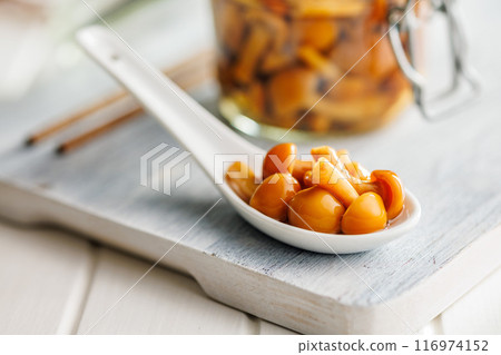 Pickled nameko mushrooms.Traditional japanese mushrooms in ceramic spoon on white table. 116974152