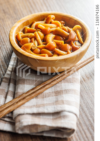 Pickled nameko mushrooms.Traditional japanese mushrooms in bowl on wooden table. 116974166