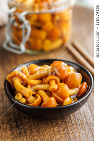 Pickled nameko mushrooms.Traditional japanese mushrooms in bowl on wooden table. 116974169