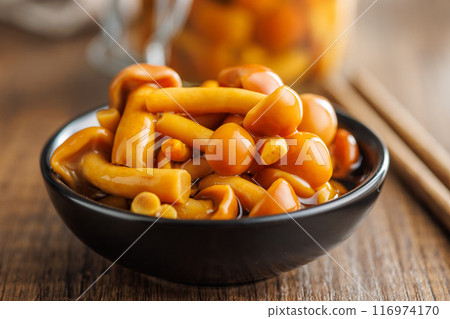Pickled nameko mushrooms.Traditional japanese mushrooms in bowl on wooden table. 116974170