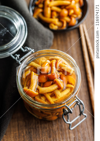 Pickled nameko mushrooms.Traditional japanese mushrooms in jar on wooden table. 116974171