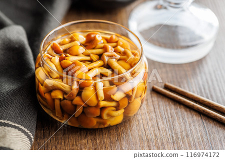 Pickled nameko mushrooms.Traditional japanese mushrooms in jar on wooden table. 116974172