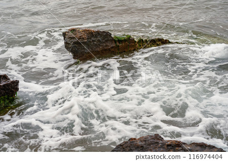 dynamic ocean waves on rugged shore dynamic ocean waves on rugged shore 116974404