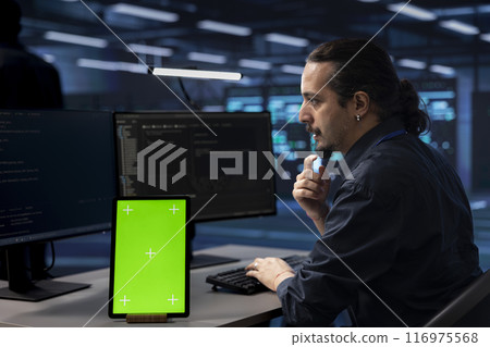 Technician using isolated screen screen tablet to check for signs of imminent failure in data center. IT expert working on mockup device to prevent damages in server farm, monitoring critical systems 116975568