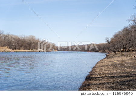 A gorgeous view of water near trees and plants at a local park in Minnesota. 116976040