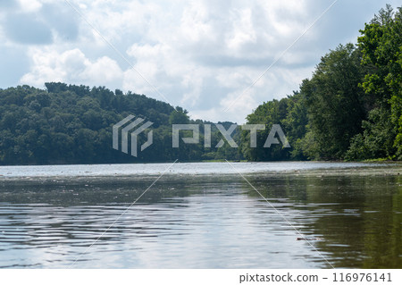 A gorgeous view of water near trees and plants at a local park in Minnesota. A gorgeous view of water near trees and plants at a local park in Minnesota. 116976141