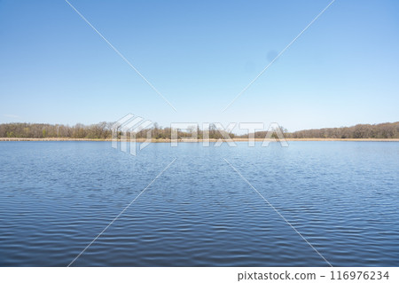 A gorgeous view of water near trees and plants at a local park in Minnesota. A gorgeous view of water near trees and plants at a local park in Minnesota. 116976234