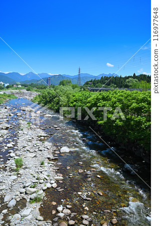 Clear waters of the Uono River, upstream from Tategara Bridge, mountain and river scenery, Yuzawa Town, Niigata Prefecture 116977648