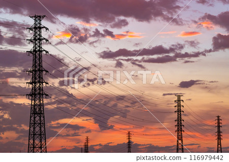 A sunset after a thunderstorm and a row of power transmission towers b-1 116979442