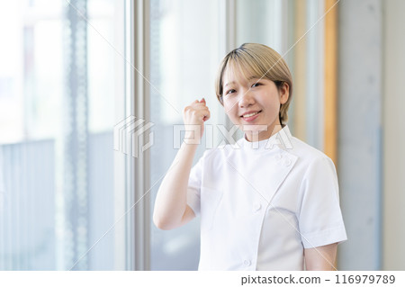 Casey 一位年輕的女性脊椎按摩師，金髮短髮，穿著白色外套（頭髮顏色自由，按自己的方式工作，工作環境） 116979789