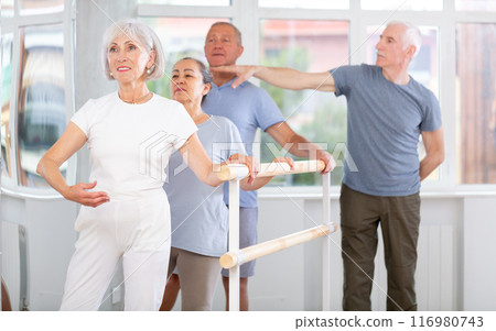 Male choreographer teaches elderly ballet lovers to keep their heads straight during ballet lesson 116980743