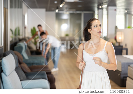Adult woman looking around in furniture store 116980831
