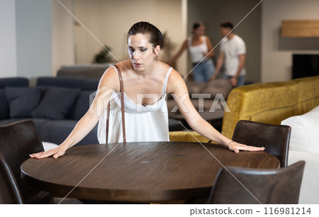 Adult woman choosing table in store Adult woman choosing table in store 116981214