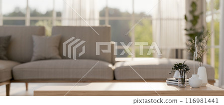 A space for displaying products on a wooden coffee table in a contemporary Scandinavian living room. A space for displaying products on a wooden coffee table in a contemporary Scandinavian living room. 116981441