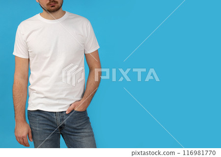 A young guy in a white t-shirt on a blue background A young guy in a white t-shirt on a blue background 116981770
