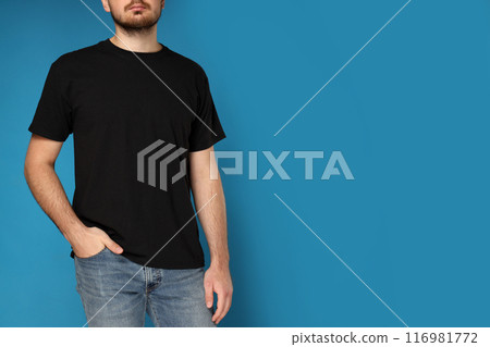 A young guy in a black t-shirt on a blue background 116981772