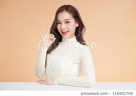 Beautiful young asian woman with clean fresh skin on beige background, Face care, Facial treatment, Cosmetology, beauty and spa, Asian women portrait. 116982708