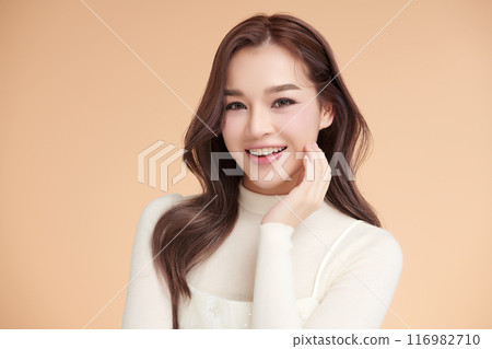 Beautiful young asian woman with clean fresh skin on beige background, Face care, Facial treatment, Cosmetology, beauty and spa, Asian women portrait. Beautiful young asian woman with clean fresh skin on beige background, Face care, Facial treatment, Cosmetology, beauty and spa, Asian women portrait. 116982710