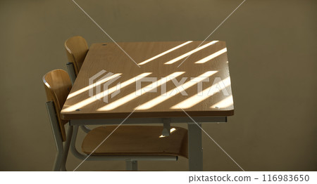 Empty classroom with wooden desks and sunlight casting shadow lines Empty classroom with wooden desks and sunlight casting shadow lines 116983650