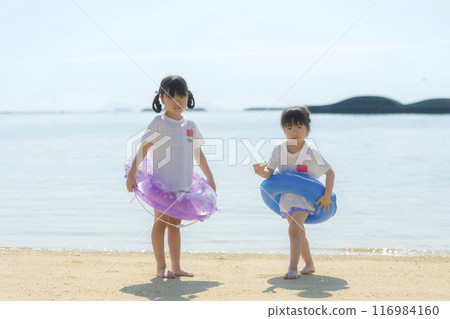 Sisters playing at the beach during summer vacation 116984160