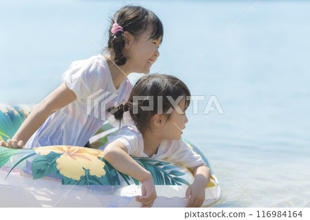 Sisters playing at the beach during summer vacation 116984164