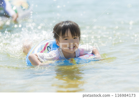 A girl playing in the sea during summer vacation 116984173