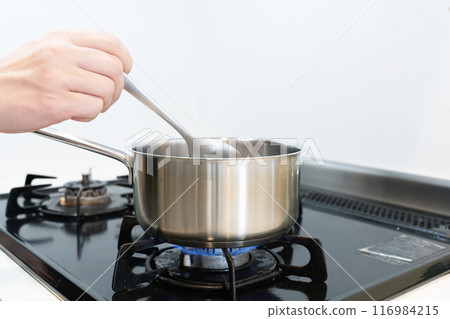 Hand pot cooking on a gas stove Hand pot cooking on a gas stove 116984215