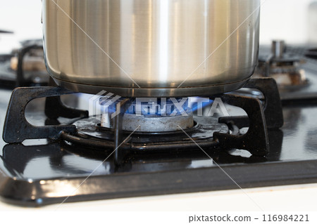 Hand pot cooking on a gas stove 116984221