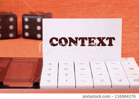 Conceptual context symbol. Copy space. Context word written on a business card on a calculator in front of an orange background 116984276