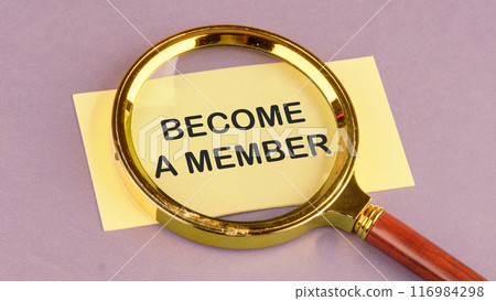 Business and education concept. Text BECOME A MEMBER through a magnifying glass on a yellow leaf, a conceptual photo Business and education concept. Text BECOME A MEMBER through a magnifying glass on a yellow leaf, a conceptual photo 116984298
