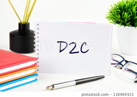 D2C direct to consumer symbol. Concept words D2C in a notebook on a light background in a composition with business accessories D2C direct to consumer symbol. Concept words D2C in a notebook on a light background in a composition with business accessories 116984321