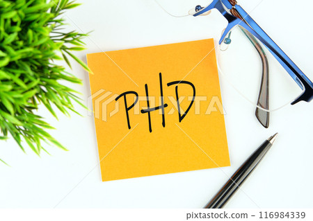Doctorate of Philosophy concept. PhD on a yellow mustard flower sticker on a white background 116984339