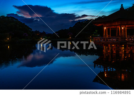 Summer 2024 Evening view of Ukimido Hall at Sagiike Pond in Nara Park. The evening sky above Ukimido Hall darkens leaving an afterglow. Summer 2024 Evening view of Ukimido Hall at Sagiike Pond in Nara Park. The evening sky above Ukimido Hall darkens leaving an afterglow. 116984891