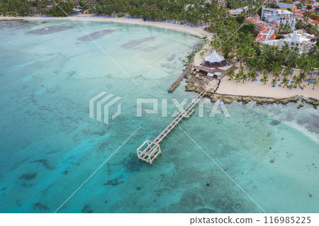 Drone view of Bayahibe beach crystal clear sea sandy beach and pier Drone view of Bayahibe beach crystal clear sea sandy beach and pier 116985225