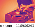 Old portable gramophone with female handA vintage gramophone, bathed in warm hues 116986293