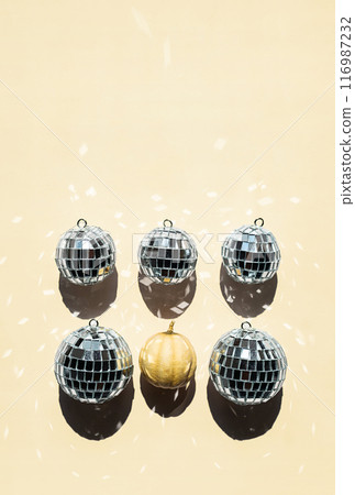 Arrangement of disco balls and tiny pumpkin. 116987232