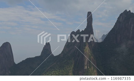 Dramatic Rock Formations Surrounded by Misty Jungle Mountains 116987335