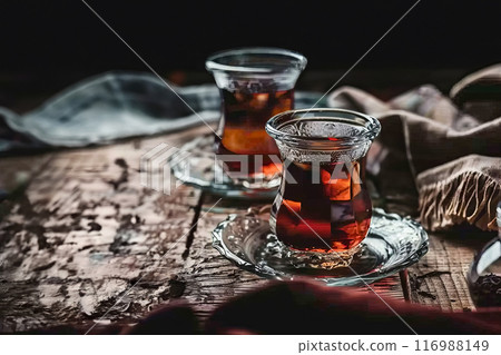Two glasses with delicious Turkish tea on a wooden table in a cafe, healthy eating concept 116988149