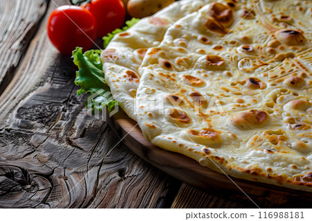 A flatbread made of thin dough with filling, most often cheese, potatoes or minced meat. The flatbread is then fried on both sides 116988181