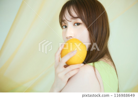 Summer woman portrait holding an orange 116988649