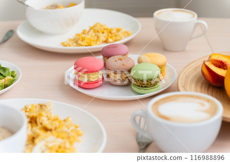Delicious breakfast with oatmeal and macaroons. Delicious breakfast with oatmeal and macaroons. 116988896