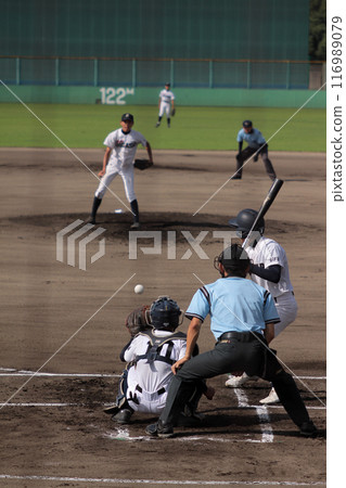 A baseball player chasing a white ball 116989079